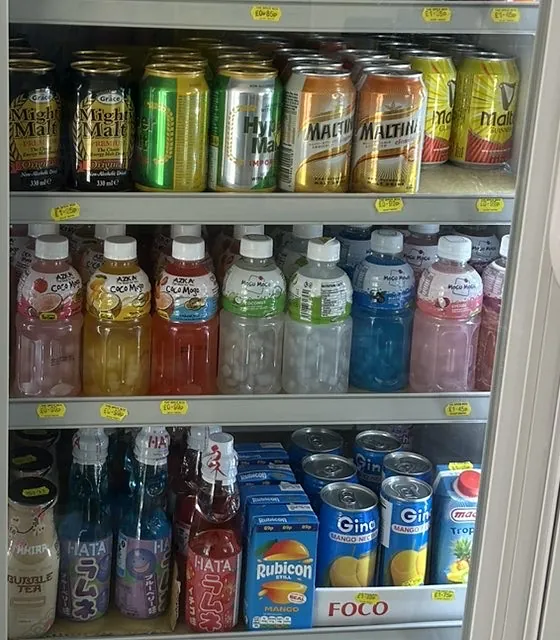 A chilled drinks fridge of malt drinks, Coco Mojo bottles, Japanese ramune and mango juice
