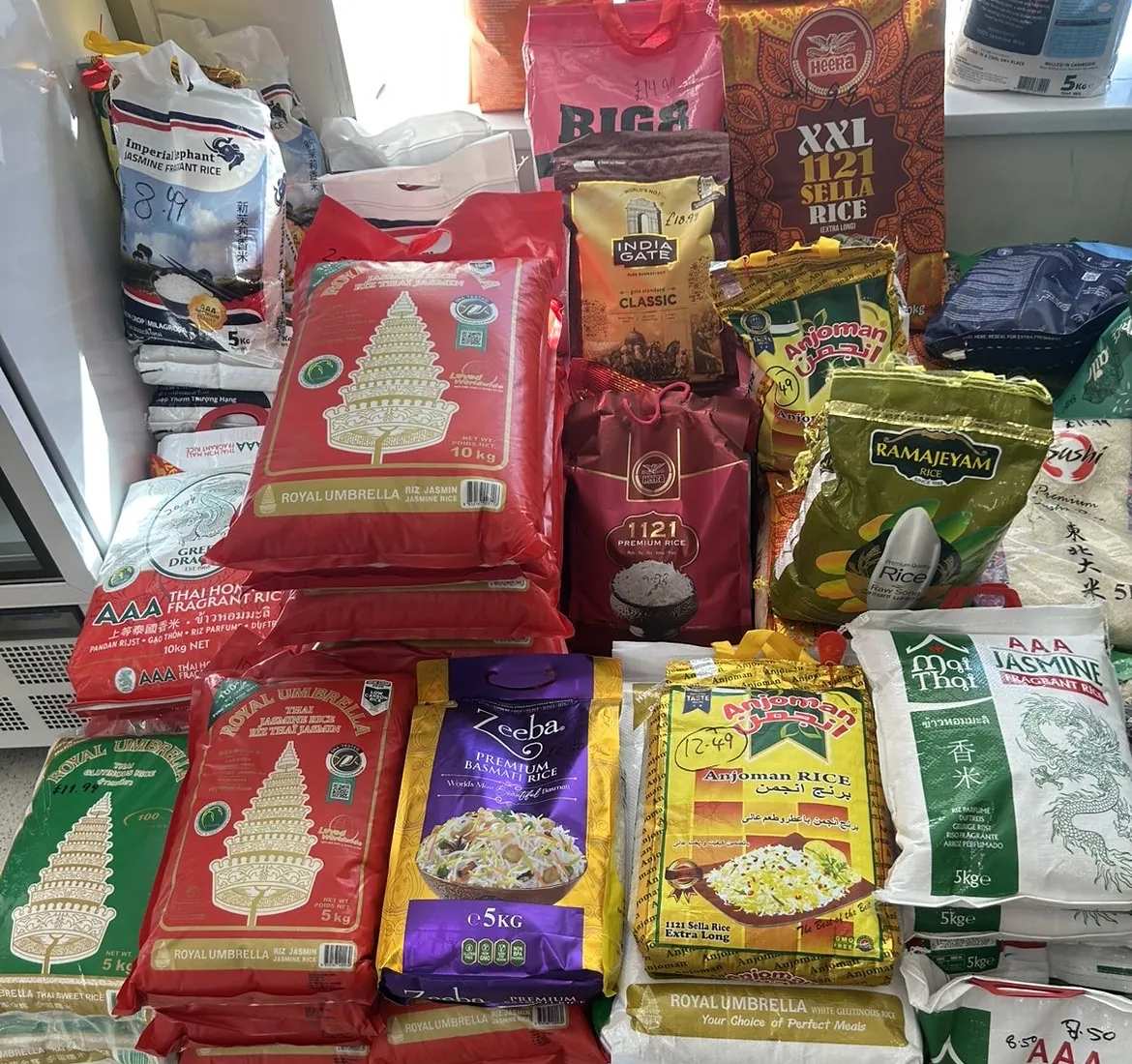 Stacked sacks of basmati, sella and jasmine rice by the shop window